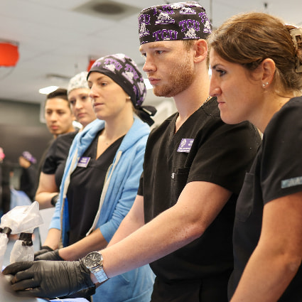 Nurse anesthesia students working in sim lab