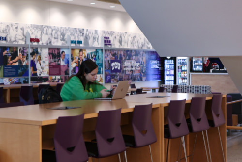 Girl sitting at table in Bass building