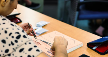 Student learning different stitching techniques