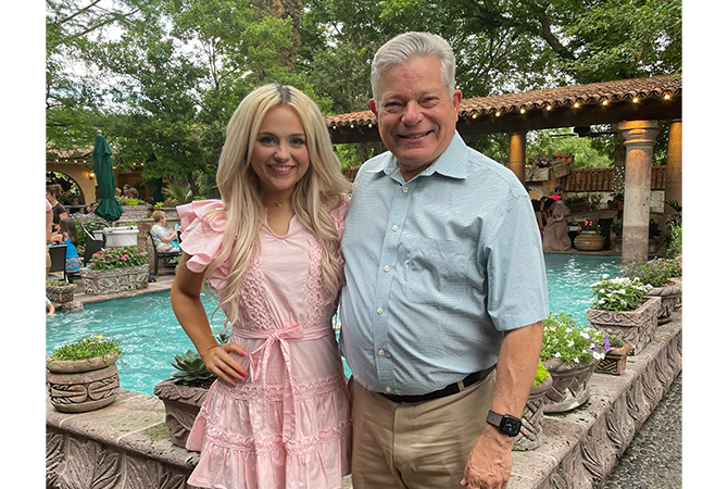 Dr. Earl Hampton pictured with TCU nursing alum Lizzie Fleming ’23 at her graduation celebration